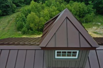 metal roof install with flashing and edging over chimney 